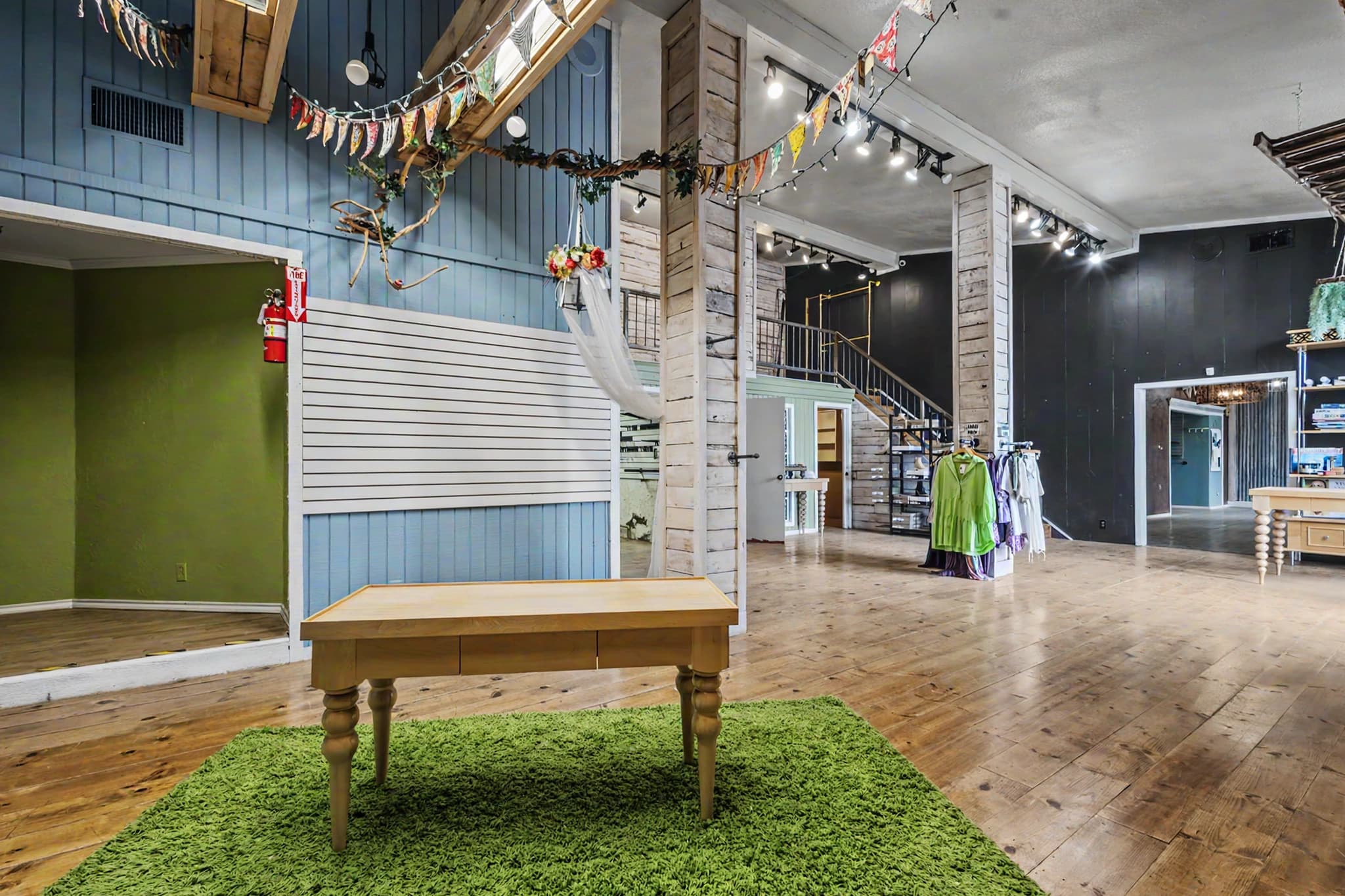 Interior of Unit 1 at the Muleshoe Art Loft Airbnb featuring open-plan living with exposed structure and gallery styling.