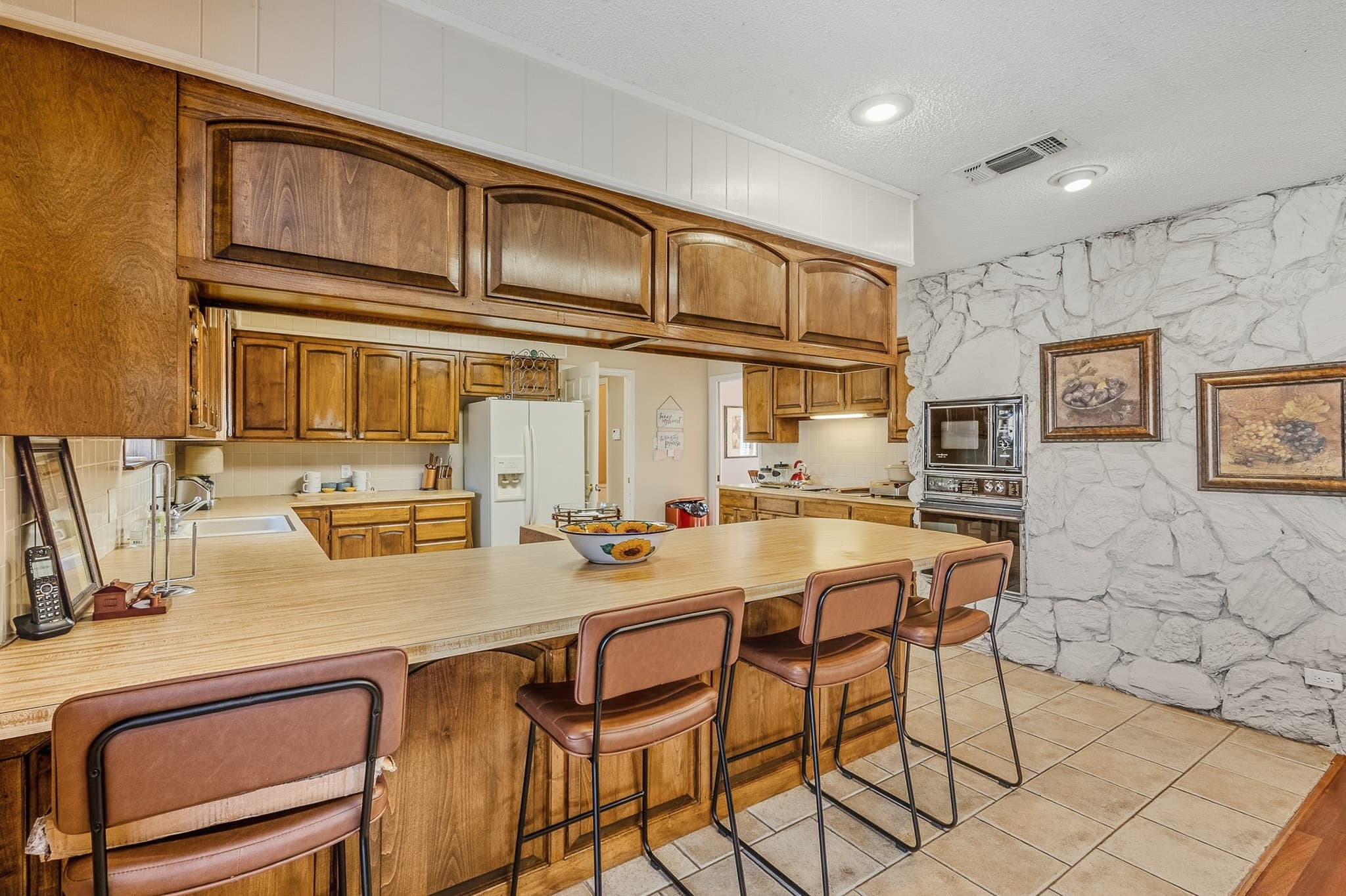 Kitchen breakfast bar with counter seating in a Muleshoe, TX listing, photographed for MLS use.