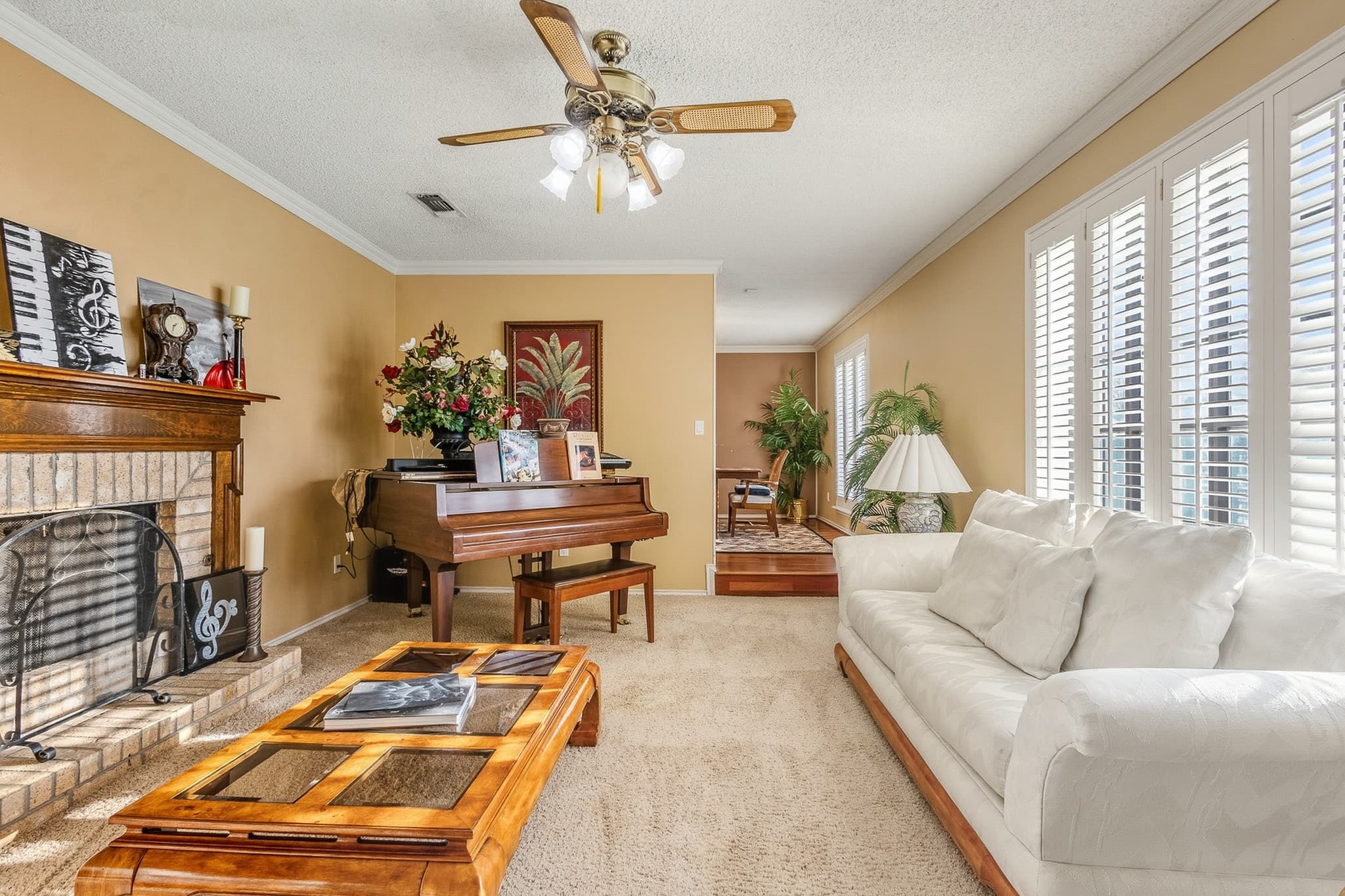 Bright living room with open sightlines to the dining area and natural window light in a Muleshoe, TX listing.