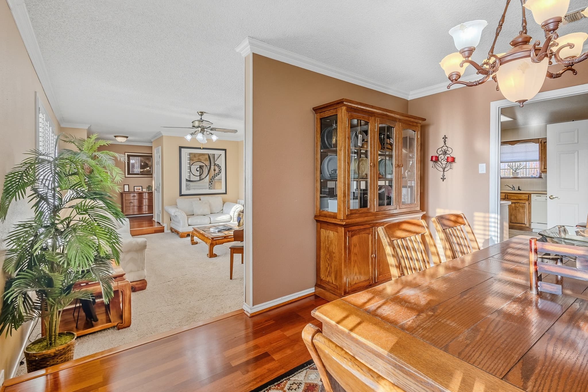 Open-concept dining and living room in a Lubbock listing, framed for video walkthrough