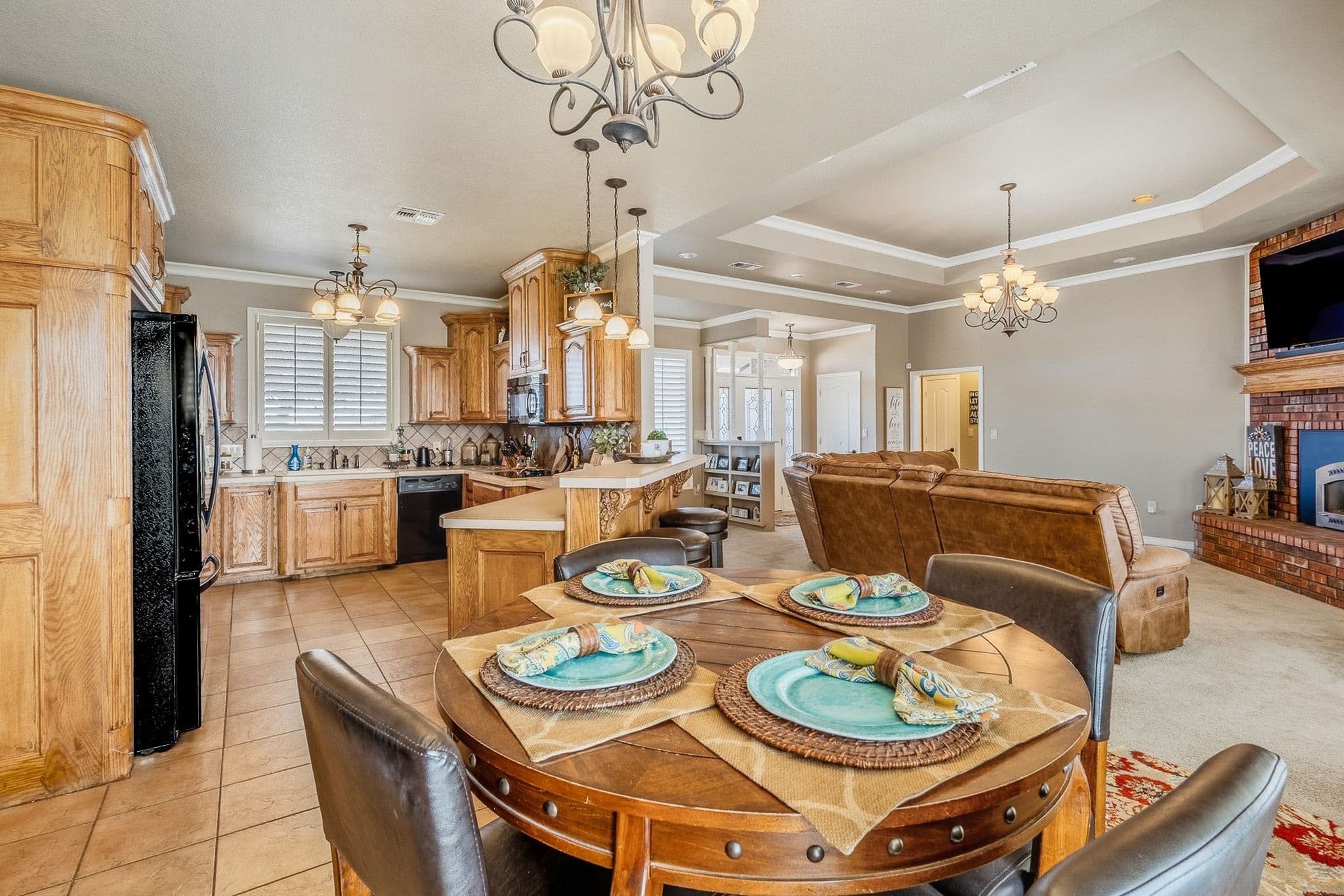 Formal dining room in a Muleshoe, TX listing with chandelier, wood table setting, and neutral walls.