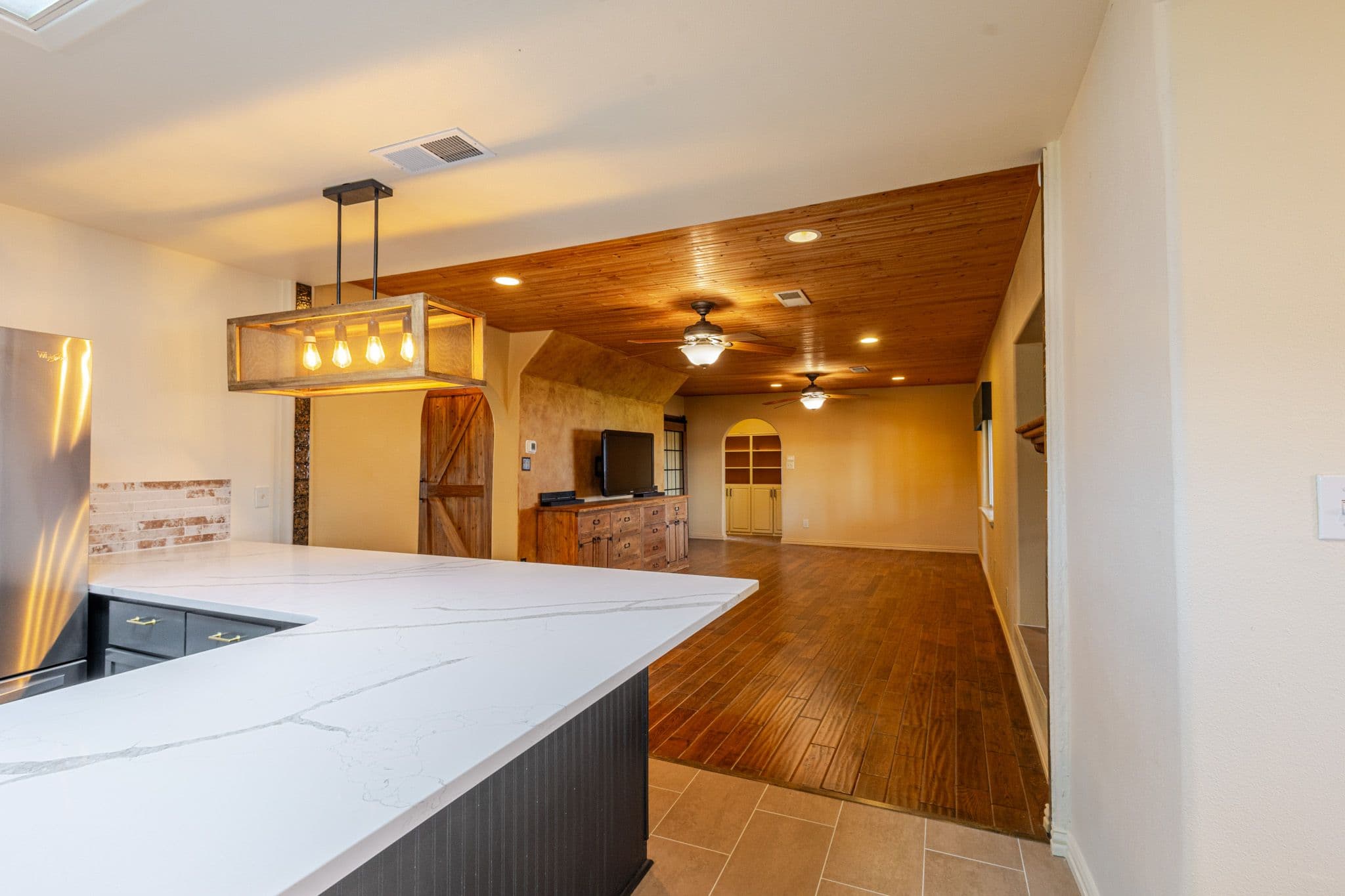 Interior shot of chandelier and side view of living room located in Clovis New Mexico
