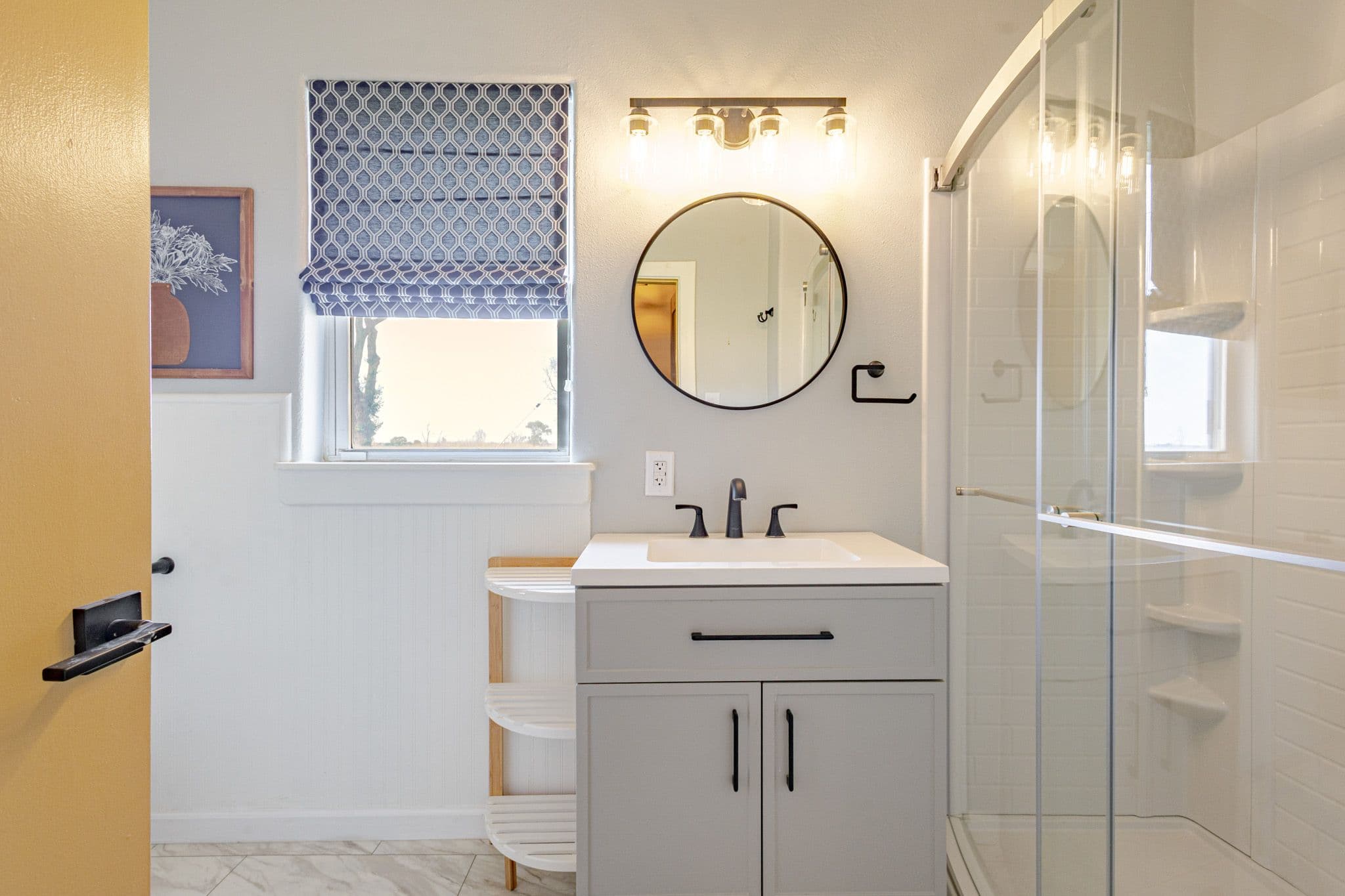Interior shot of guest bathroom showcasing sink and standing shower inside countryside home located in Clovis New Mexico