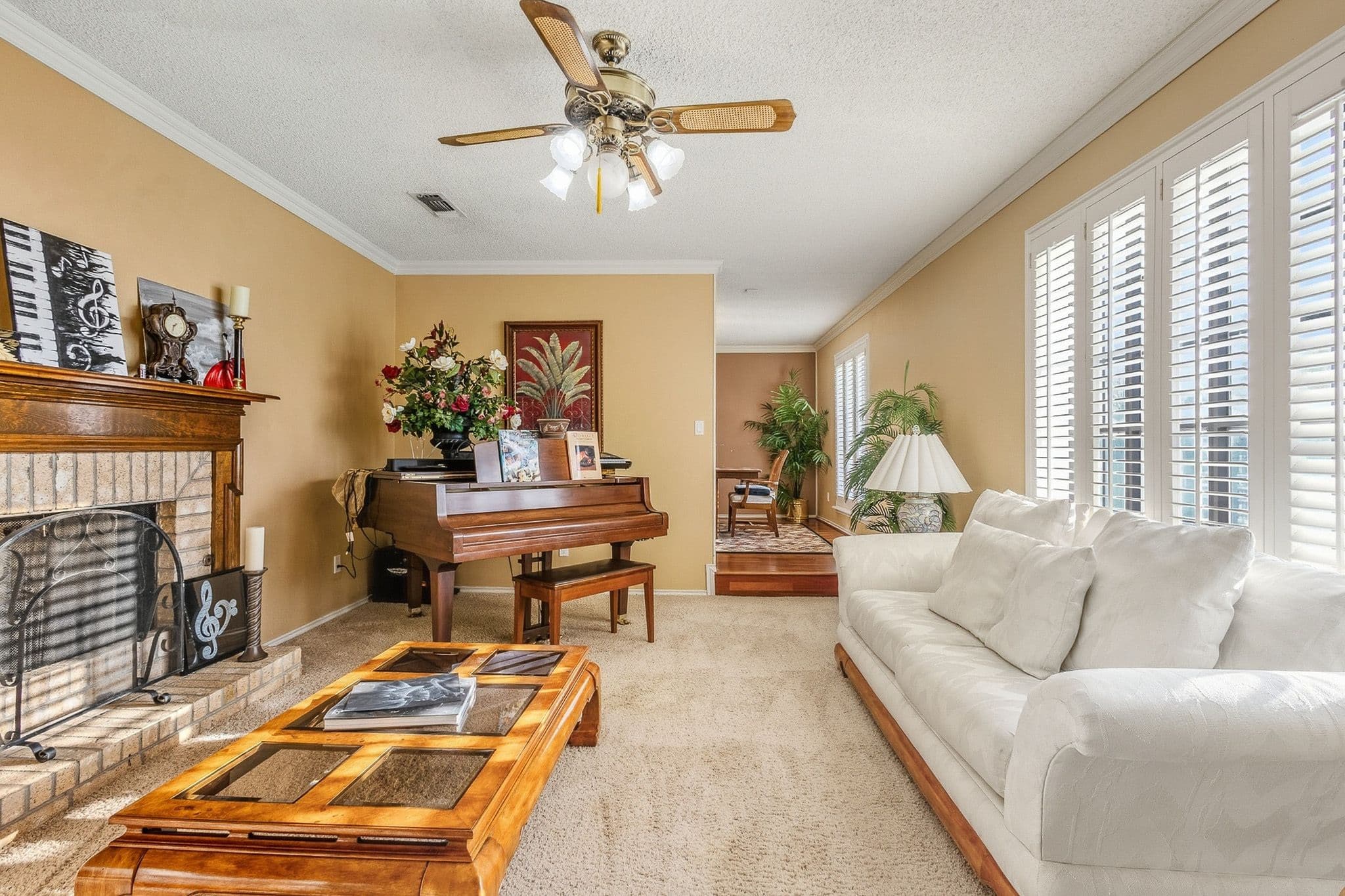 Bright living room with open sightlines to the dining area and natural window light in a Muleshoe, TX listing.