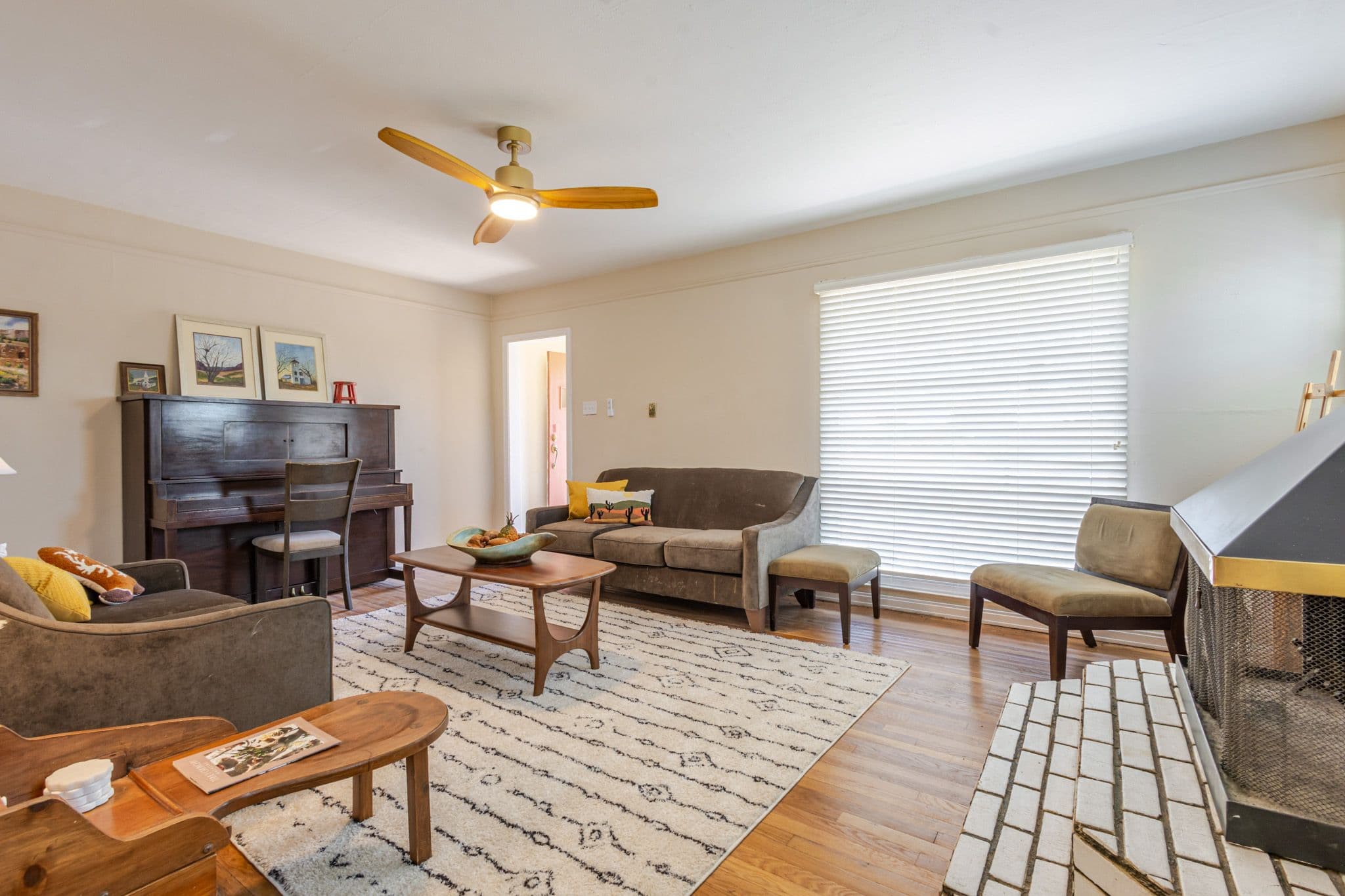 Interior corner shot of living room facing front window and front door. Airbnb located in Clovis, New Mexico