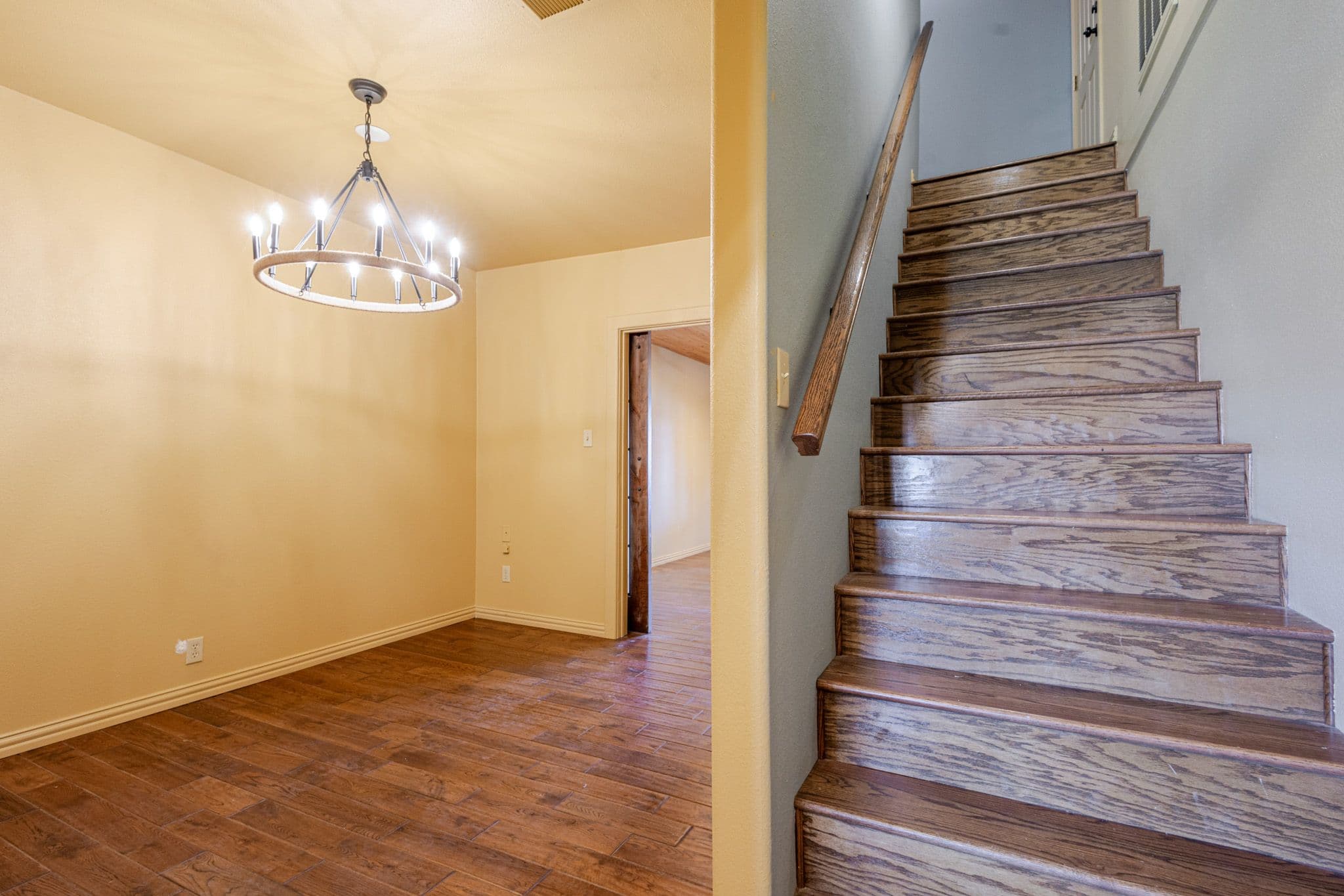 Interior shot of stairs and dining room of countryside home.