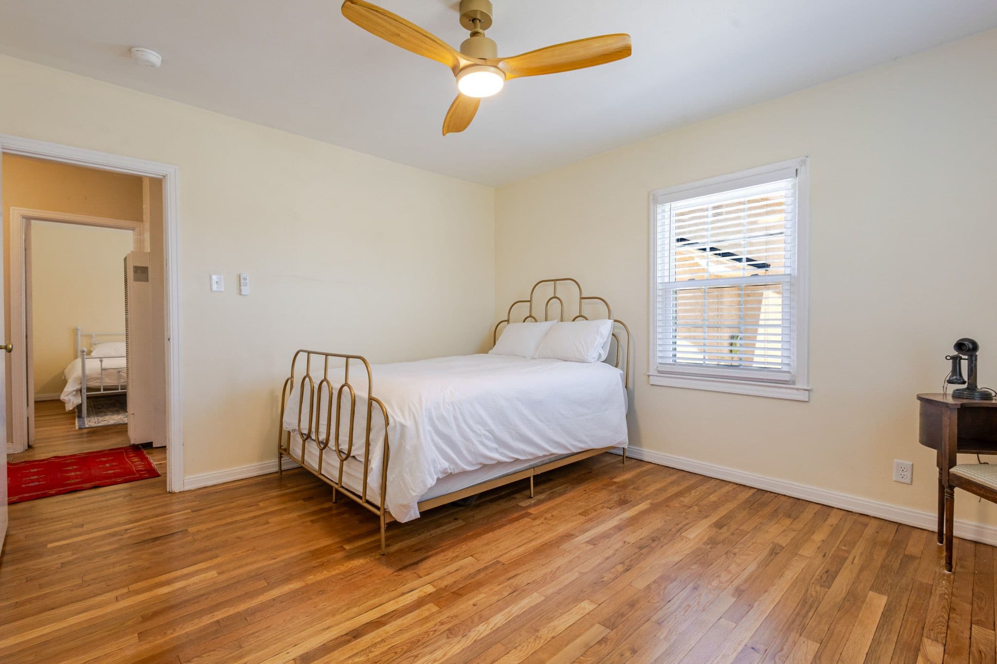 Interior corner shot of bedroom showing hallway and other bedroom. Airbnb located in Clovis New Mexico