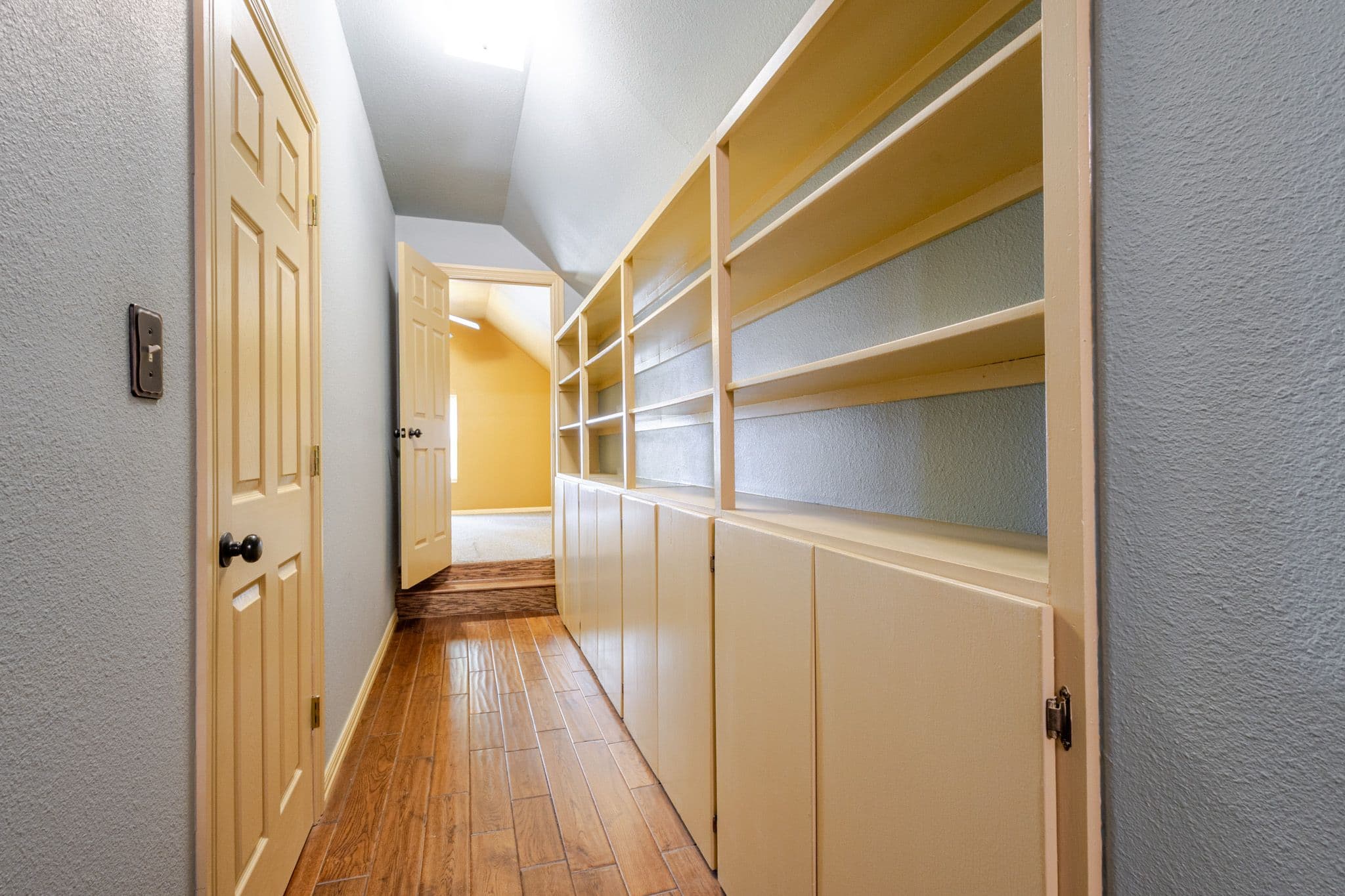Interior shot of narrow upstairs hallway.