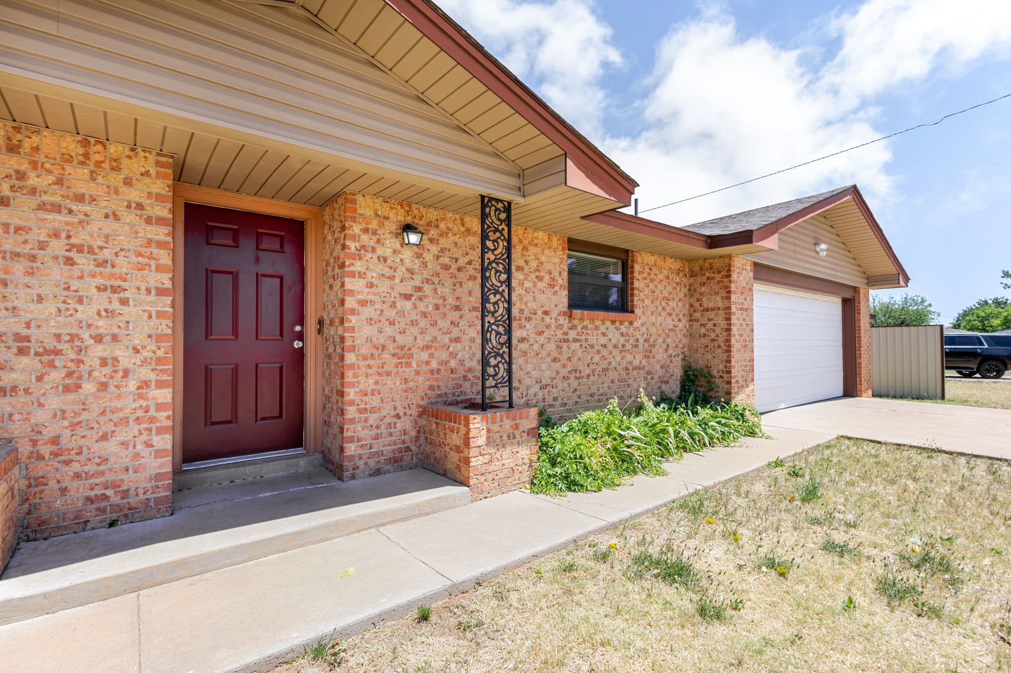 Exterior shot of front of brick home located in Clovis, NM.